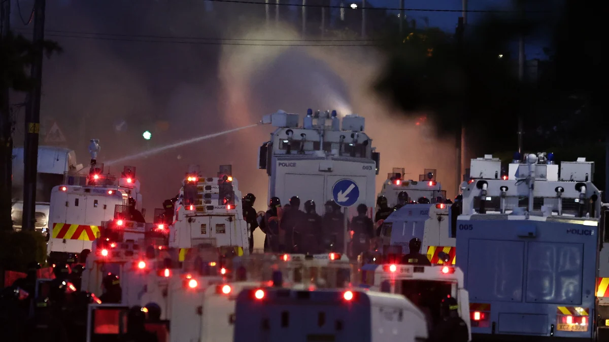 Police blast water cannons at protesters amid unrest over stabbing in Belfast