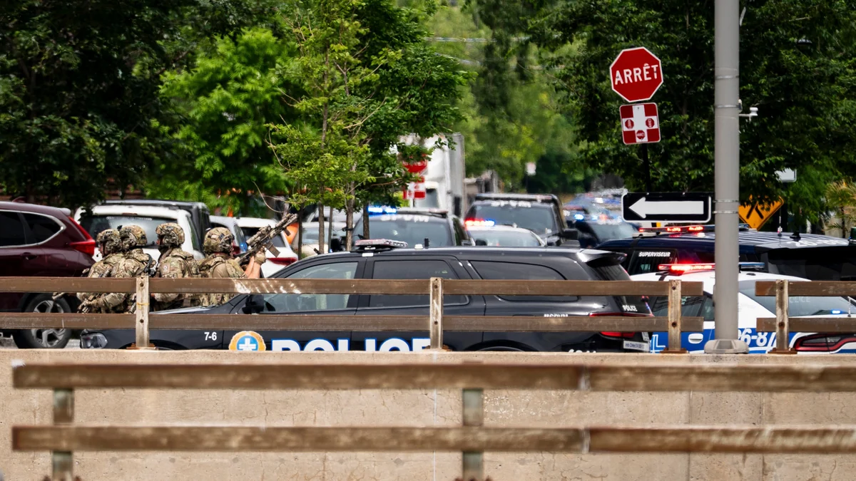 Gunman kills an officer at a Montreal hotel before being shot dead, police say